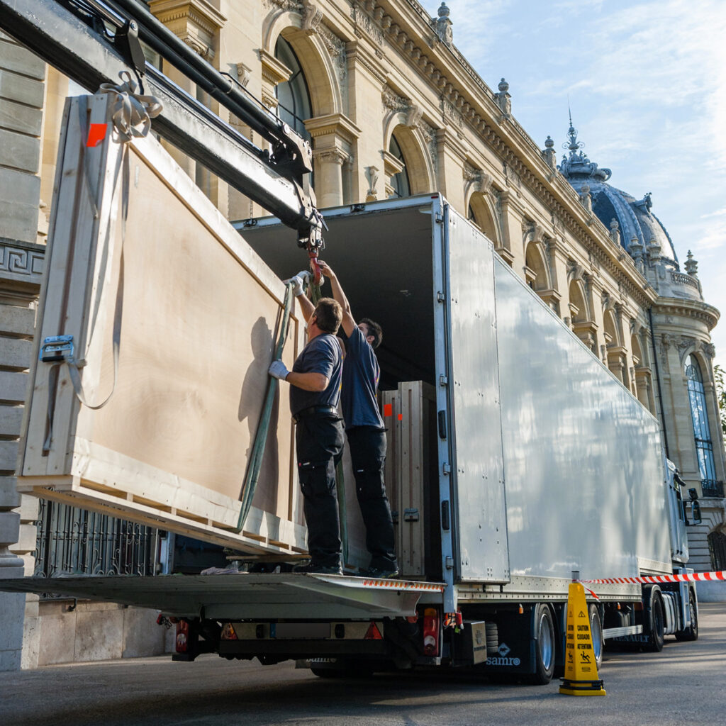 Déchargement et manutention d'une œuvre d'art protégée par une caisse de transport adaptée